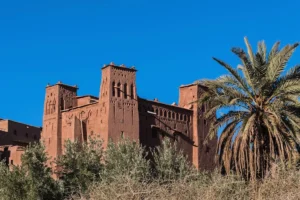 Aït Benhaddou is a historic ksar along the old caravan route between the Sahara and Marrakech in Morocco. Ouarzazate is a city located south of the Moroccan High Atlas Mountains, known as the gateway to the Sahara Desert.