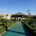 people walking on pathway near white concrete building during daytime