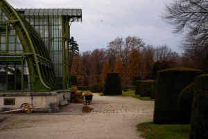 Greenhouse structure with manicured garden and trees