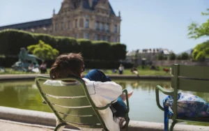 Person relaxing by a pond in a paris park